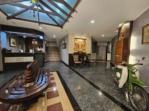 a lobby with a bench and a motorcycle in it at Baan Suksiri Hotel Hua Hin in Hua Hin +20 photos