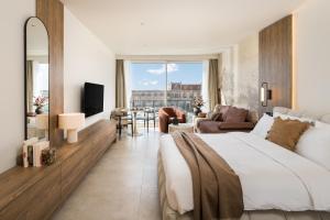 a bedroom with a large bed and a living room at PortoVista Luxury Urban Suites by BiNoBi! in Thessaloniki