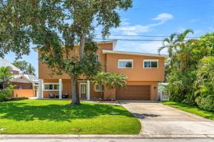 a large orange house with a driveway at 464 Indian Creek Dr in Cocoa Beach