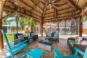 a patio with blue chairs and a wooden roof at 464 Indian Creek Dr in Cocoa Beach