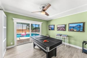 a living room with a ping pong table in it at 464 Indian Creek Dr in Cocoa Beach