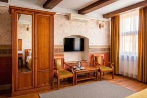 a room with a table and chairs and a television at Heban Hotel in Toruń +33 photos