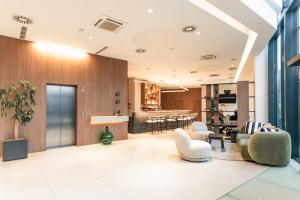 an open living room with a kitchen and dining room at Hotel Garden Hill in Velika Gorica