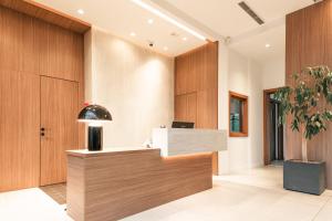 an office with a reception desk and a potted plant at Hotel Garden Hill in Velika Gorica