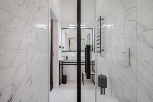 a white bathroom with a sink and a mirror at Budapest Cereja Boutique in Budapest +47 photos