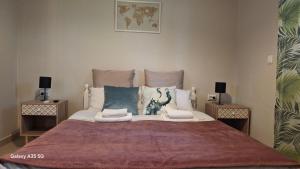 a bedroom with a large bed with two side tables at Trousas Double Apartment in Roda