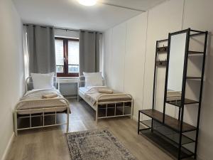 a small room with two beds and a mirror at City Apartment Hamburg Work Relax Repeat in Hamburg