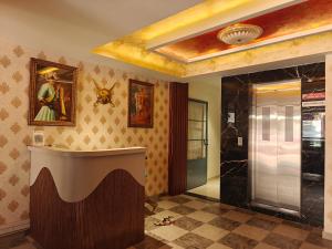 a bathroom with a shower and a counter in a room at Hotel Jagdamb Kolhapur in Kolhapur +27 photos