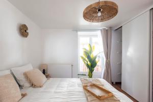 a bedroom with a white bed and a large window at Casa Dina - in Chalon-sur-Saône