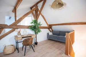 a living room with a table and a blue couch at Casa Dina - in Chalon-sur-Saône
