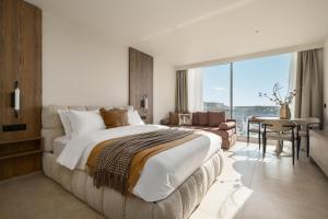 a bedroom with a large bed and a large window at PortoVista Luxury Urban Suites by BiNoBi! in Thessaloniki