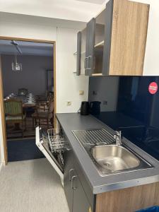 a kitchen with a sink and a dining room at City Apartment Hamburg Work Relax Repeat in Hamburg