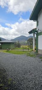 a gas station with a green building and a field at URA Agua Apartamento 2 in Sopuerta