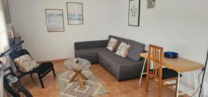 a living room with a couch and a table at URA Agua Apartamento 2 in Sopuerta