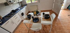 a kitchen with a table with chairs and a stove at URA Agua Apartamento 2 in Sopuerta +7 photos