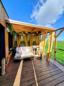a bed on the deck of a house at Glamour tinyhouse in Muret