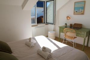 a bedroom with a bed and a desk and a window at Azur Cancale in Cancale +23 photos