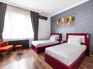 a hotel room with two beds and a chair at Perazre Hotel in Istanbul +61 photos