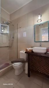 a bathroom with a toilet and a sink and a shower at Trousas Double Apartment in Roda +29 photos