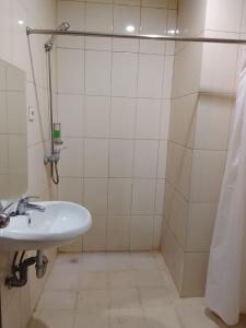 a bathroom with a sink and a shower at Miracle Hotel Manado in Manado +33 photos