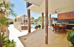 a patio with a table and chairs and a pool at Gecko Lodge Kalbarri in Kalbarri