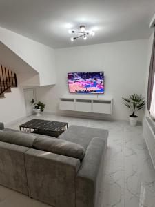 a living room with a couch and a flat screen tv at Mtskheta View Hotel in Mtskheta