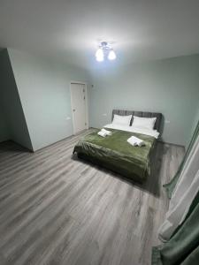 a bedroom with a bed with two towels on it at Mtskheta View Hotel in Mtskheta