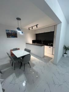 a white room with a table and chairs and a kitchen at Mtskheta View Hotel in Mtskheta