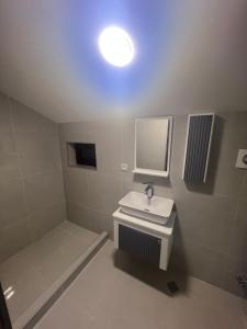 a white bathroom with a sink and a mirror at Mtskheta View Hotel in Mtskheta +18 photos