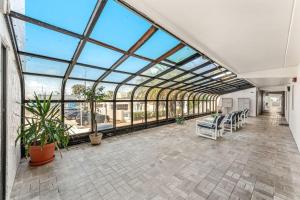 a large conservatory with a large glass ceiling at Boardwalk 205 in Cocoa Beach +30 photos