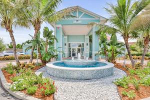 a fountain in front of a house with palm trees at Cape Crossing 103 in Merritt Island