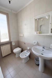 a white bathroom with a sink and a toilet at Attico Zamagna in Cesenatico +38 photos