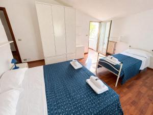 a bedroom with two beds with towels on them at Attico Zamagna in Cesenatico