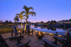 a pool with chairs and a palm tree and lights at 126 Deleon Rd in Cocoa Beach