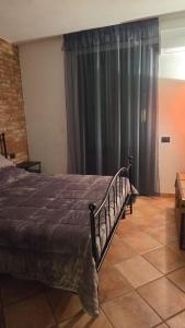 a bedroom with a bed and a large window at The Cozy Nest in Santa Maria a Monte