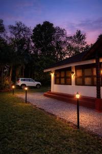 a car parked in front of a house at night at Coorg Mystere Luxury Home Stay in Madikeri