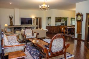 a living room filled with furniture and a clock at Safari Park Hotel in Nairobi