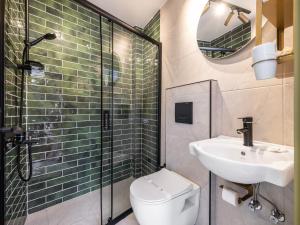 a bathroom with a sink and a toilet and a mirror at Perazre Hotel in Istanbul
