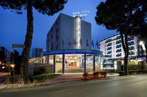 a building on a city street at night at Hotel San Michele in Bibione