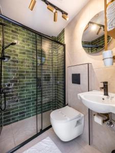 a bathroom with a toilet and a sink and a shower at Perazre Hotel in Istanbul