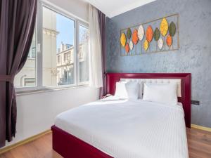a bedroom with a large bed and a window at Perazre Hotel in Istanbul