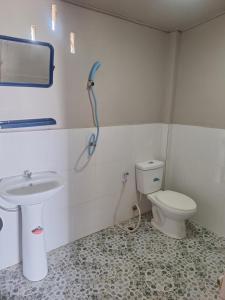 a bathroom with a toilet and a sink at champa resort in Don Det
