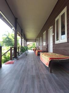 a room with benches on the side of a building at champa resort in Don Det
