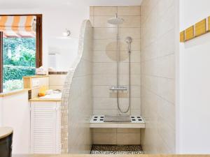 a shower in a bathroom with a shower bench at chambres d'hôtes villa OZ in Bidart +15 photos