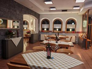 a restaurant with tables and chairs in a room at Landhaus am Brubbel in Wallenborn