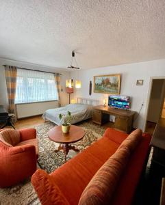 a living room with a couch and a table at Strand Haus Am Walde in Trassenheide