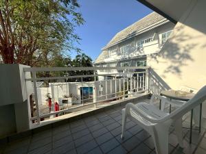 a balcony with a white railing and a fire hydrant at Baan Suksiri Hotel Hua Hin in Hua Hin