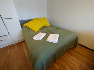 a bed in a room with two towels on it at As 8 Viima inc Sauna in Valkeakoski