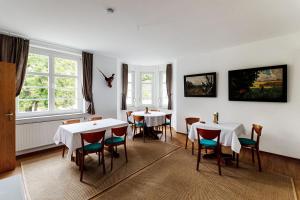 a dining room with two tables and chairs at Monteurzimmer Jerichow in Jerichow