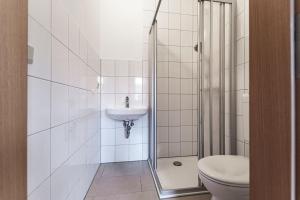 a bathroom with a shower and a toilet and a sink at Monteurzimmer Jerichow in Jerichow